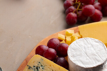 Cheese and grapes on plate close up