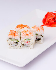 Shrimp sushi close up, Japanese cuisine. Asian cuisine concept. Served on a white plate over white background