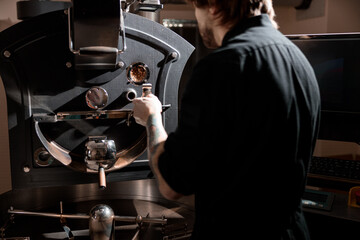 confident coffee roaster man is checking preparation process
