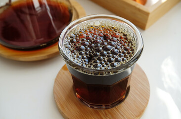 Very bubbly aerated coffee in a glass. Manual brewing, third wave specialty concept