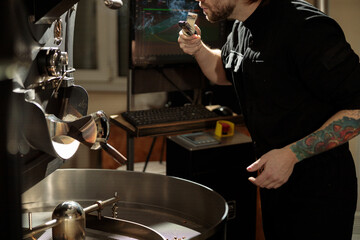 confident coffee roaster man is checking preparation process