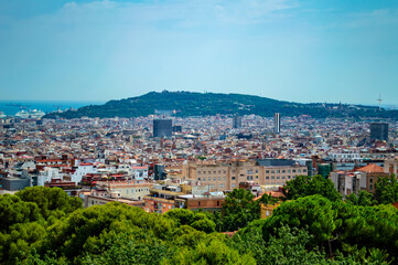 Fototapeta na wymiar Barcelona, Spain - July 26, 2019: Aerial view of buildings and skyscrapers of Barcelona, Spain