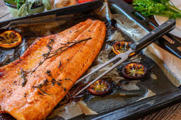 grilled halved salmon fillet on a tray