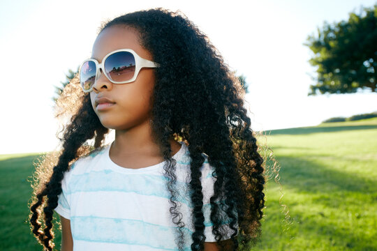 Young mixed race girl wearing sunglasses