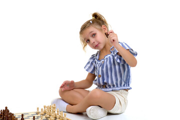 Little girl playing chess.On white background.