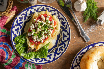 Grilled eggplant stuffed with feta cheese and sweet pepper on an Uzbek plate
