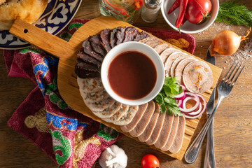 Cold cuts of chicken, beef, tongue and balyk with sauce and red onion
