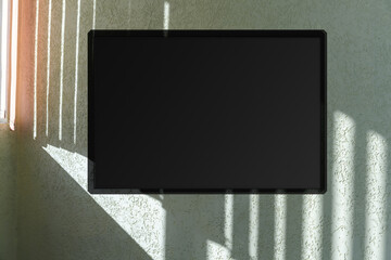 modern led tv stand with empty black screen hanging on wall with shadows