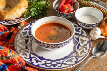 Chuchvara. Traditional Uzbek lamb soup with dumplings and sour cream