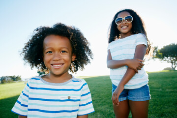 Young mixed race girl and boy, brother and sister, outdoors