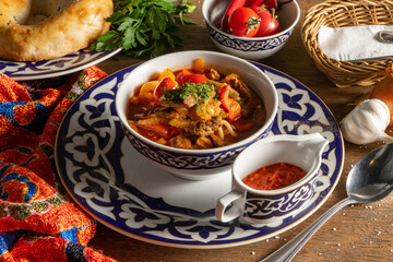 Lagman. Uzbek soup with noodles, lamb, vegetables, herbs and adjika.