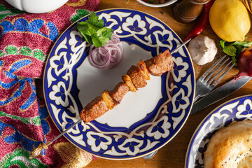 Small portion of lamb shish kebab with red onion and parsley
