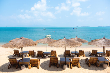Tropical style of wooden table ,chairs and umbrella in beach cafe