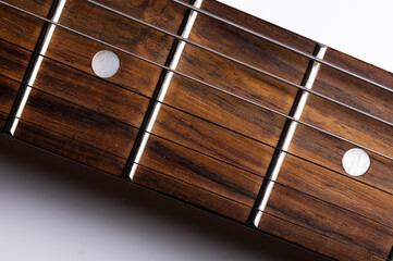 Close-up elements of electric guitar on gray background