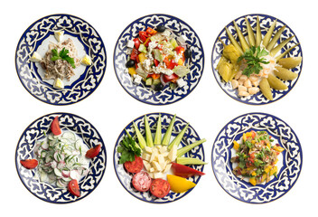 A set of salads and cold appetizers in plates with a traditional Uzbek pattern.