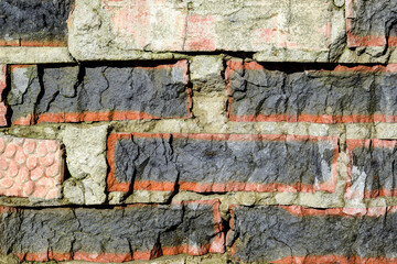 Destroyed bricks in old brickwork. Old dilapidated brick wall, natural texture, uneven surface....