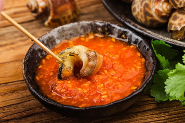 Babylonia areolata shellfish seafood on bowl ready for eat or cooked