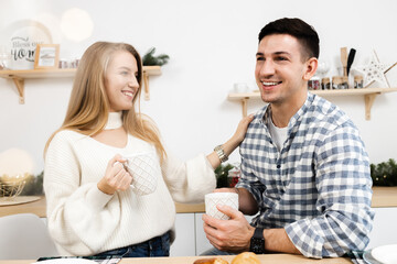 Portrait of a young sweet couple in kitchen