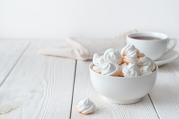Fototapeta na wymiar French meringue dessert in a deep bowl on a white background.