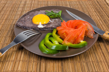 Fried egg with beaten egg white mixed with black olives