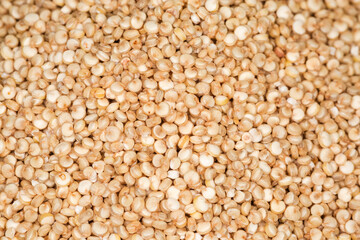 Background of white quinoa seeds on pile, selective focus