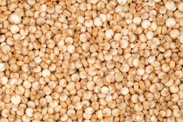 Background of raw white quinoa seeds close-up