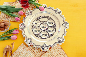 Pesah celebration concept (jewish Passover holiday). Traditional pesah plate text in hebrew: Passover, horseradish, celery, egg, bone, maror, sweet dates jam