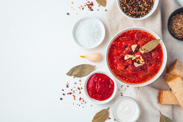Delicious borscht with garlic and bay leaf on a white background.