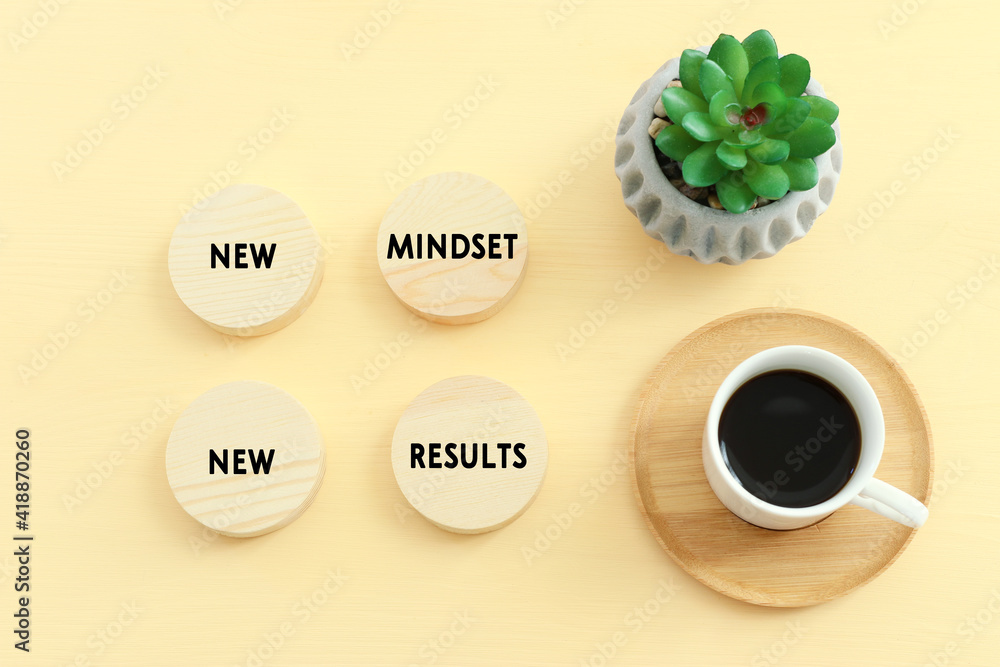 Aufkleber concept image with new mindset new results text. top view of office table