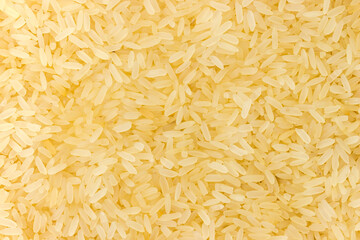 Background of raw medium-grained parboiled rice close-up