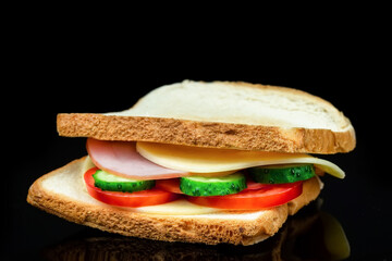 Delicious appetizing sandwich on a black background