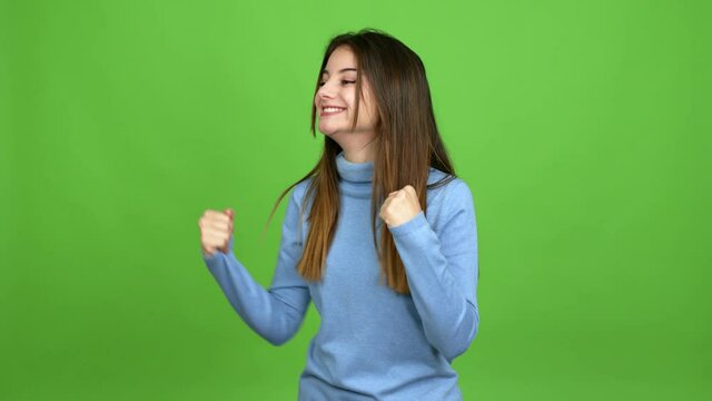 Young caucasian woman celebrating a victory and surprised to be successful over isolated background. Green screen chroma key