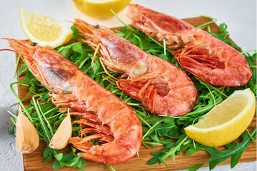Red raw prawns, close up. Fresh shrimps with lemon and rucola. Seafood background