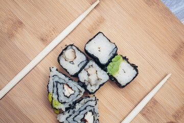 sushi rolls chopsticks food ration delicacy wood board