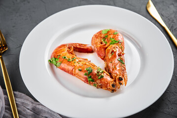 Two shrimps in shape of heart on the plate, top view. Love concept