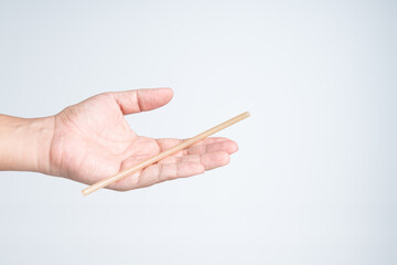 Hand holding decompostable sugarcane straw