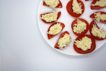 Fototapeta na wymiar Tomatoes stuffed with cheese with garlic and mayonnaise.