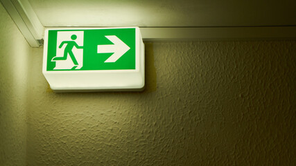 Emergency exit sign on wall in house as a notice sign