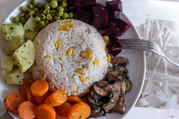 rice and cooked vegetables on the plate, concept vegetarian food