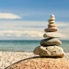 Fototapeta na wymiar Zen meditation with stack of stones as a Buddhism concept