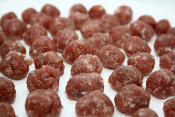 Small meatballs of ground beef and pork.