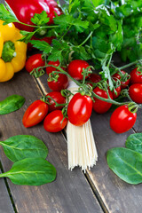 Closeup view of noodles pasta with fresh organic vegetables on wooden background.Vertical colorful healthy food concept