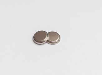 two button cell or disk cell batteries isolated on white background.