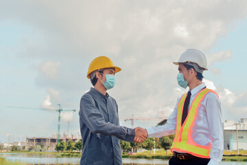 Asian man wear medical mask holding tablet working on site construction new normal protect coronavirus covid 19