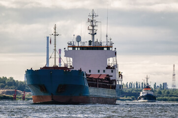 Fototapeta premium MERCHANT VESSEL - Ship on the background of coast with industrial chimneys