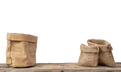Two different size burlap bags and paper container on grunge wooden  shelf with copy space isolated over white background