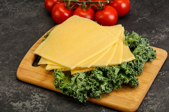 Sliced Gauda cheese over board