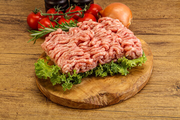 Raw pork minced meat over board