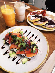 plate of pancakes and salmon toast with natural juices