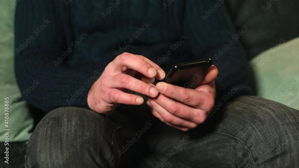 Poster checking online notifications on your phone. the man holds a gadget in his hands, uses the screen wi